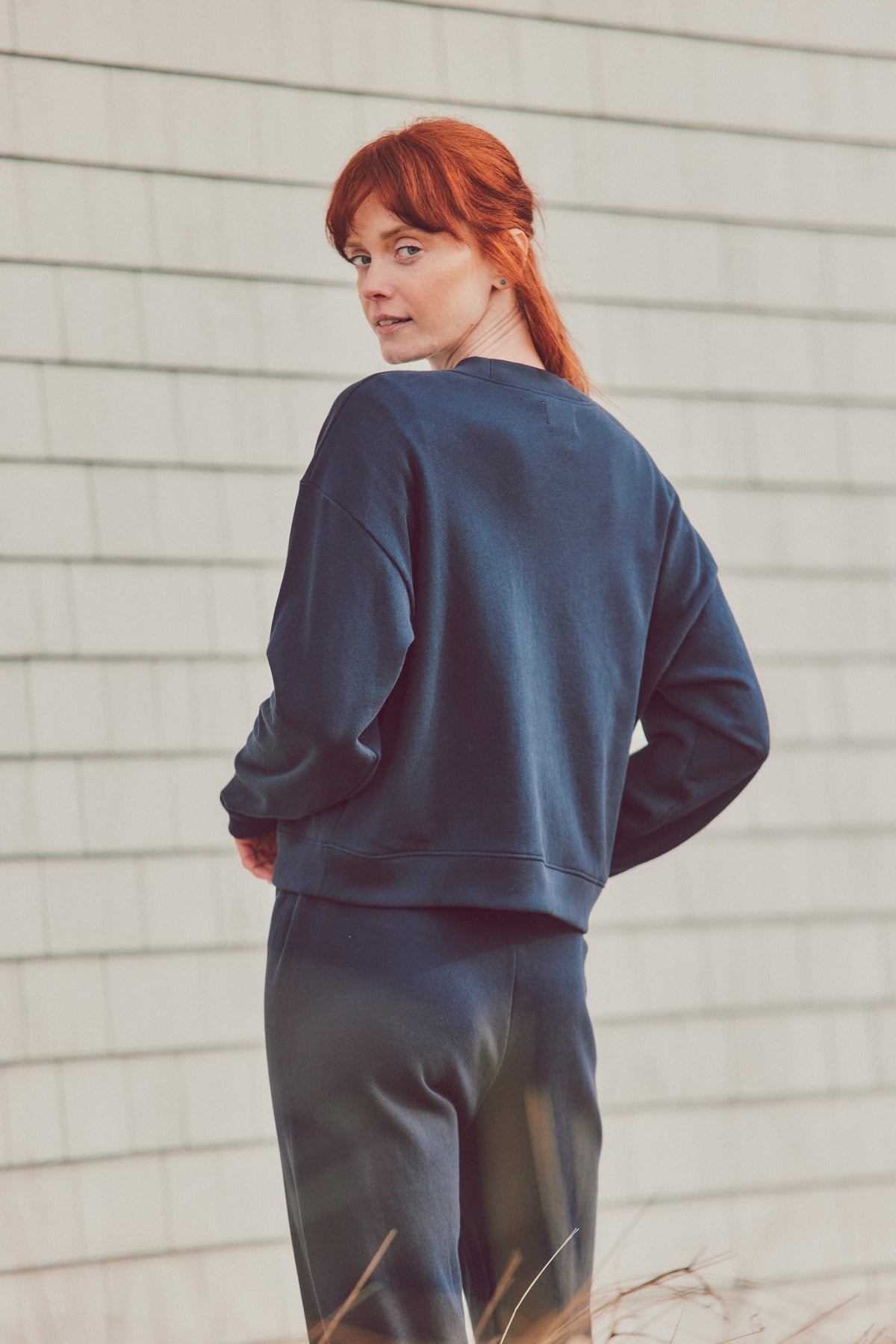 a model in a matching navy blue sweatshirt set
