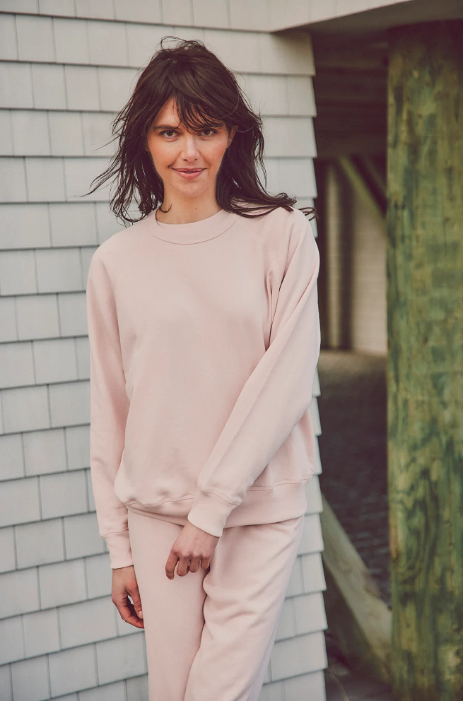 a model in pink sweatshirt and matching bottoms
