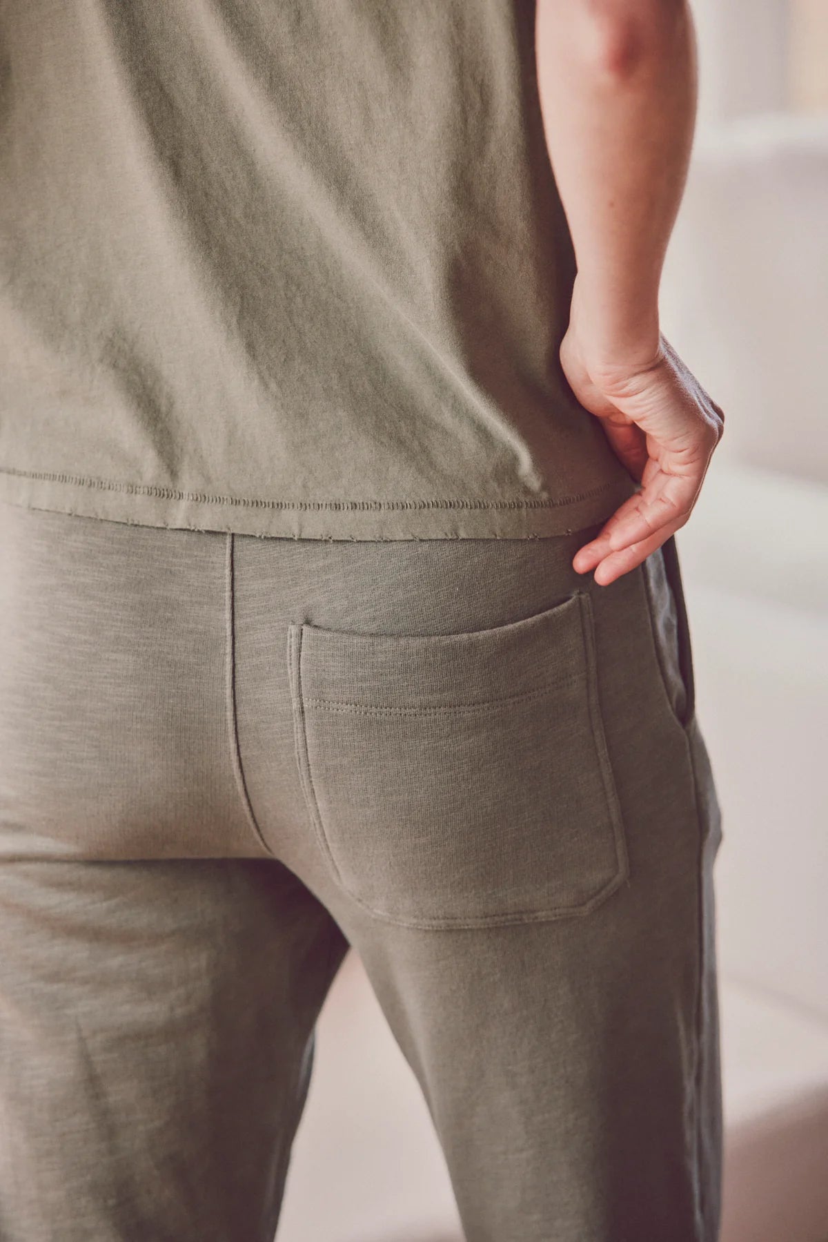  the back pocket area of a pair of green jogger pants