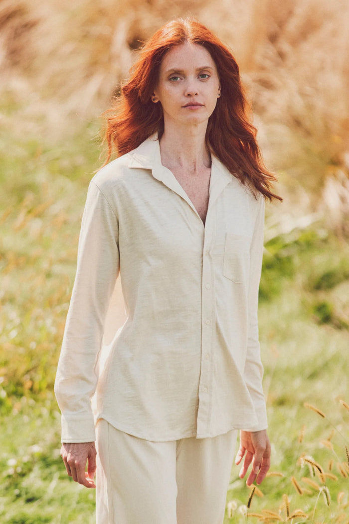 a woman in a cream button-down