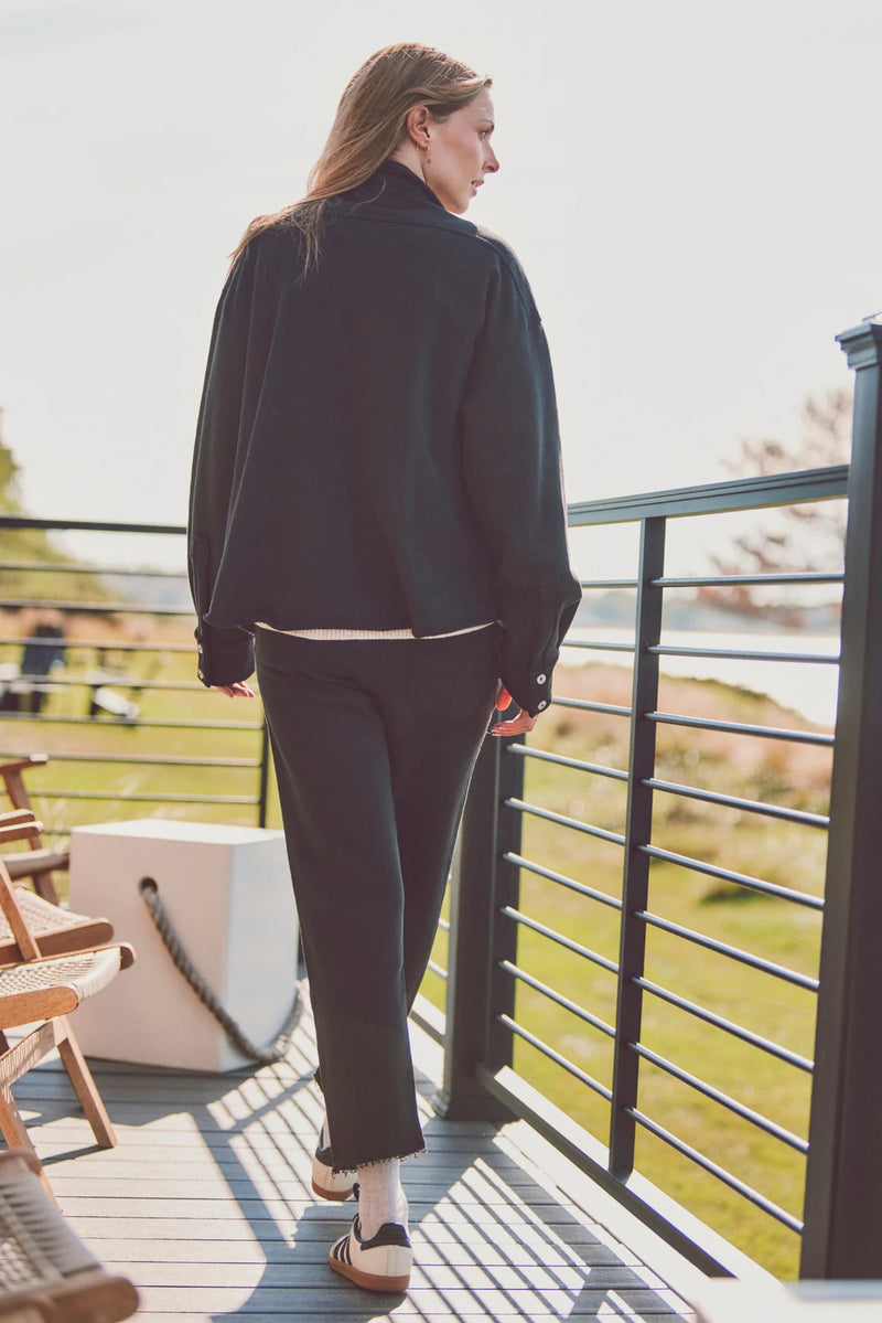 Woman wearing a black Dartmouth Jacket with matching pants