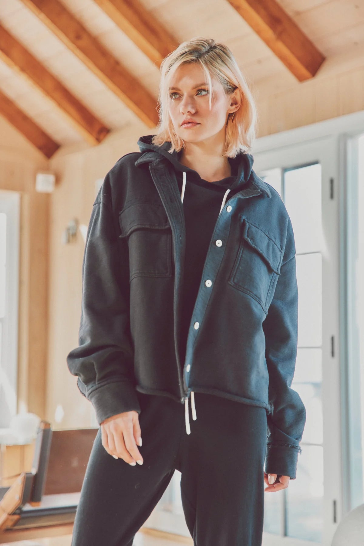 Woman in a black Dartmouth Jacket layered over a black hoodie