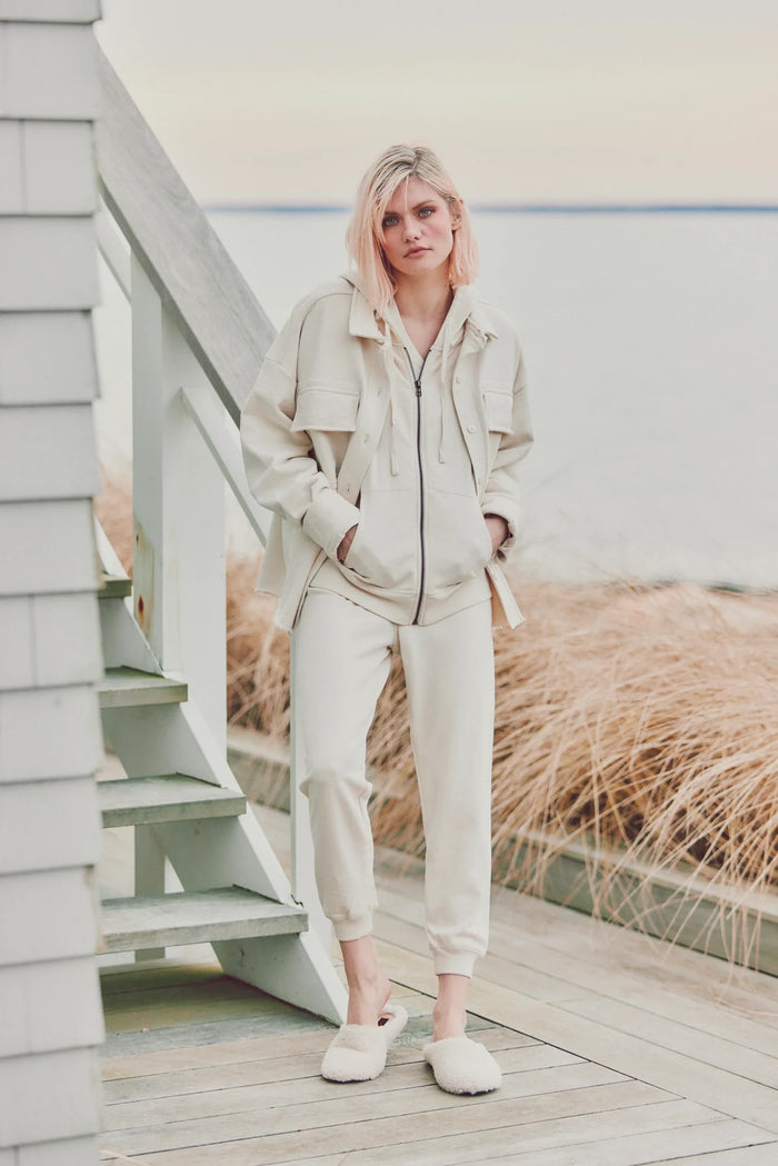 Woman wearing a cream Dartmouth Jacket and matching joggers