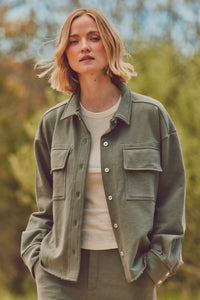 Close-up of woman in a green Dartmouth Jacket styled with a white tee