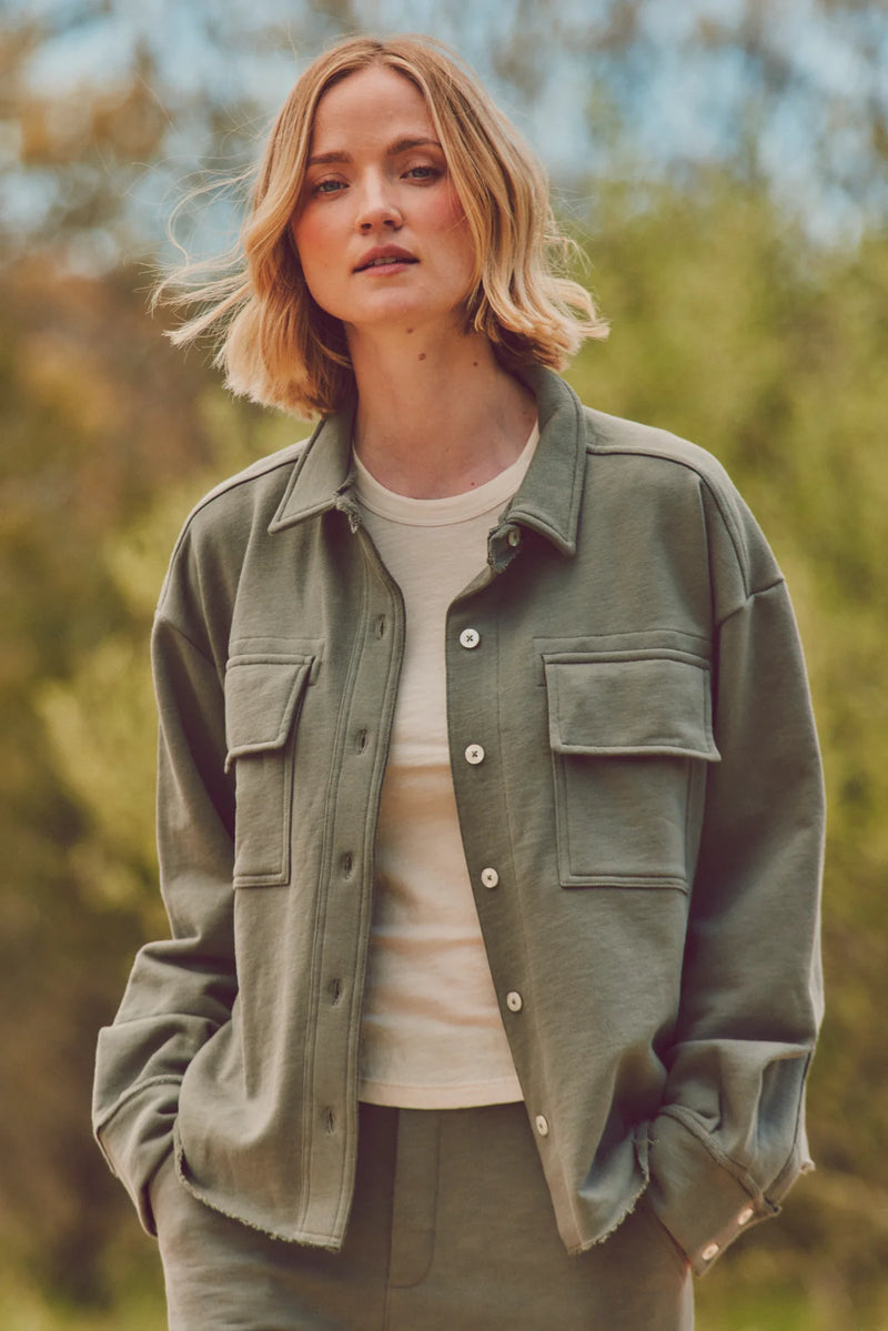 Close-up of woman in a green Dartmouth Jacket styled with a white tee