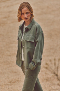 Woman wearing a green Dartmouth Jacket and joggers