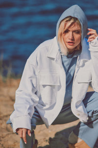 Close-up of woman in a white Dartmouth Jacket and blue hoodie