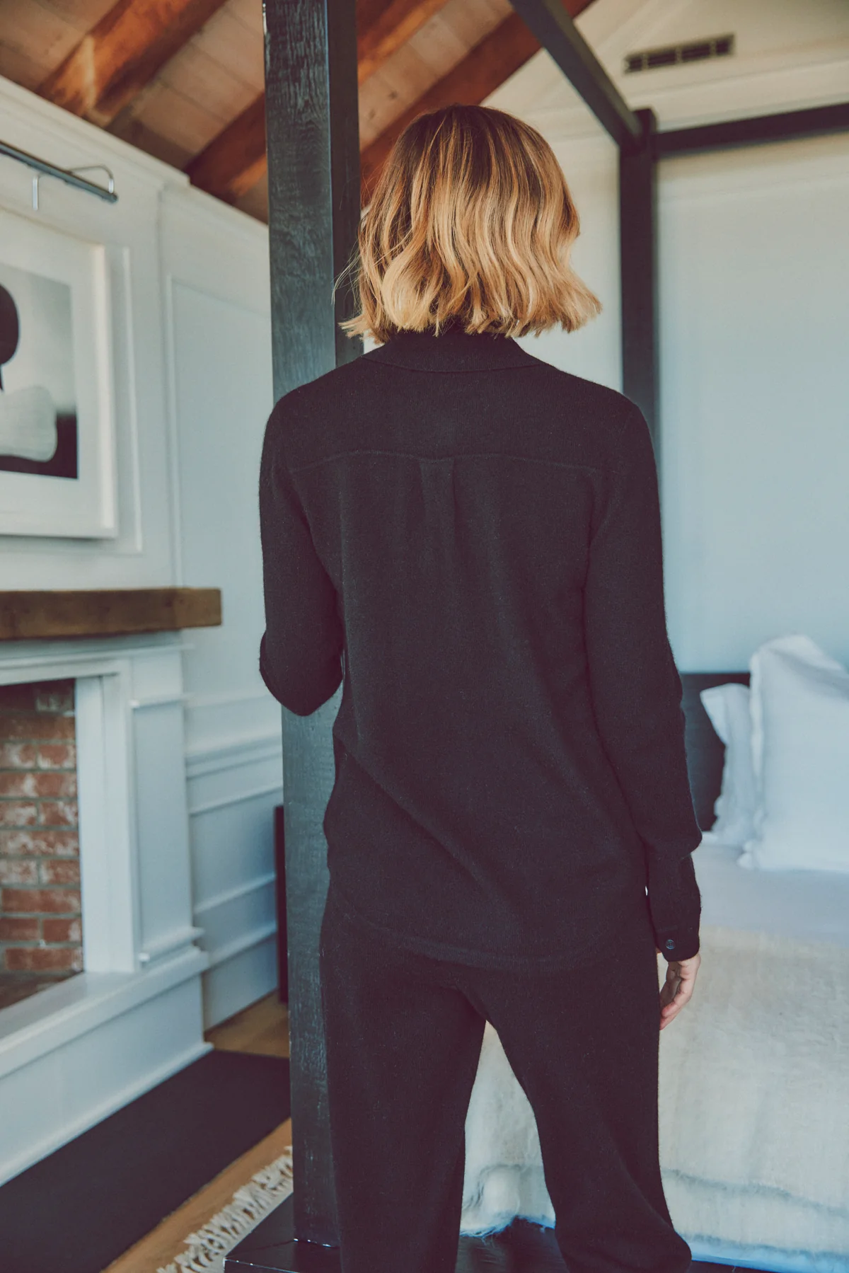 a model with her back turned in a black cashmere set