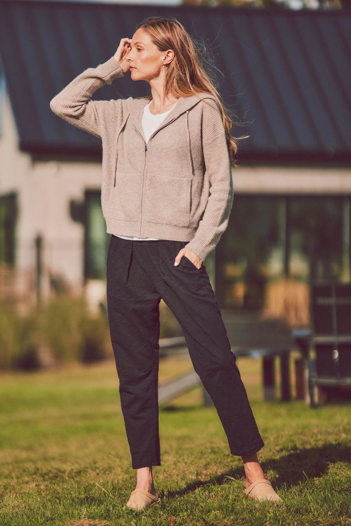 model wearing black sunset pants with a hoodie