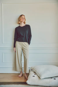 a model wearing a black long-sleeve top with the poppy pants