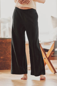 model wearing black wide-leg pants