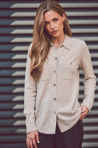 a model in a beige cashmere button-up