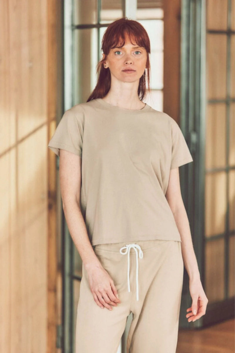 a model in a beige t-shirt and matching joggers