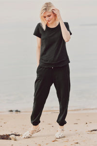 a model in black joggers and a black tee