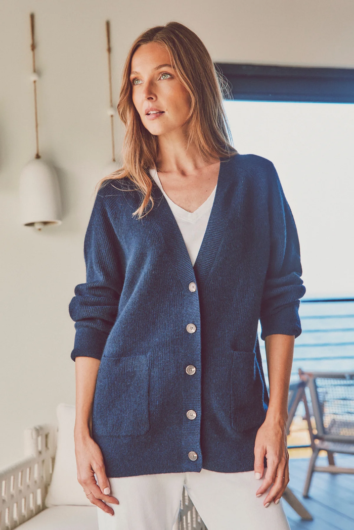 a model in a buttoned-up navy cardigan