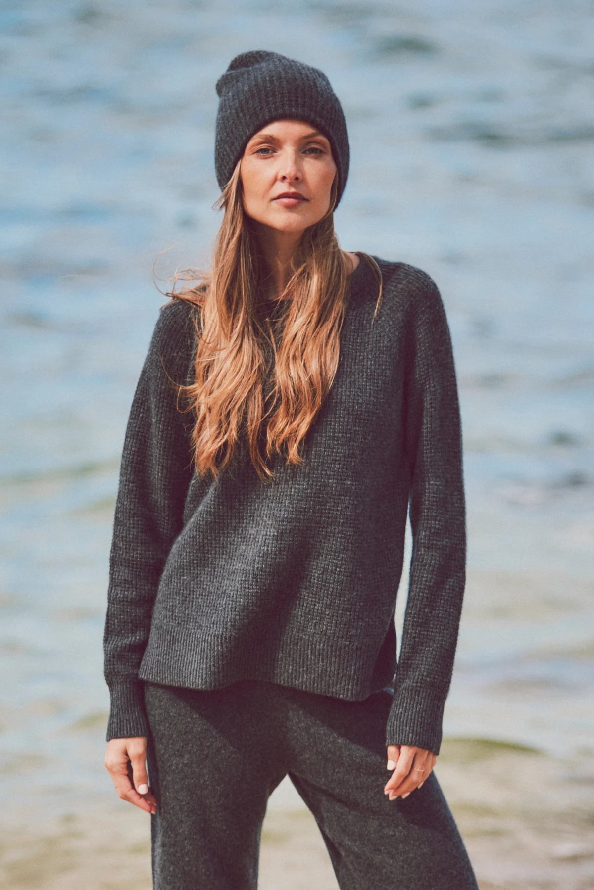 a model in a gray knit outfit