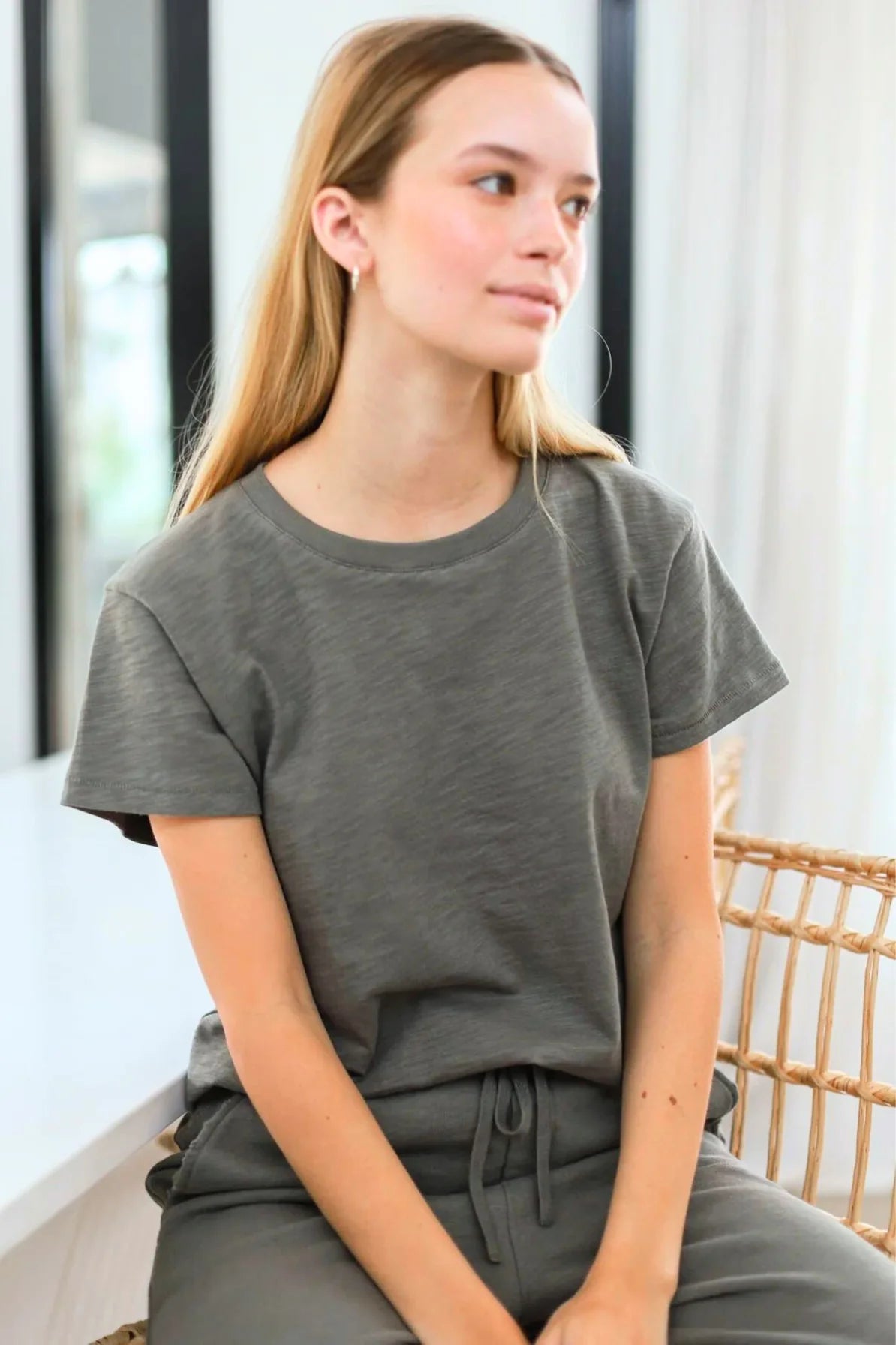 a model in a gray tee and pants