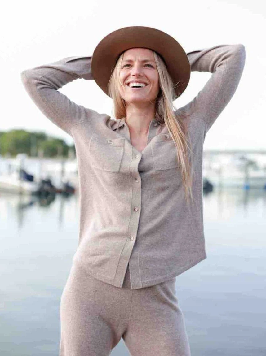 a model in a hat and beige loungewear set