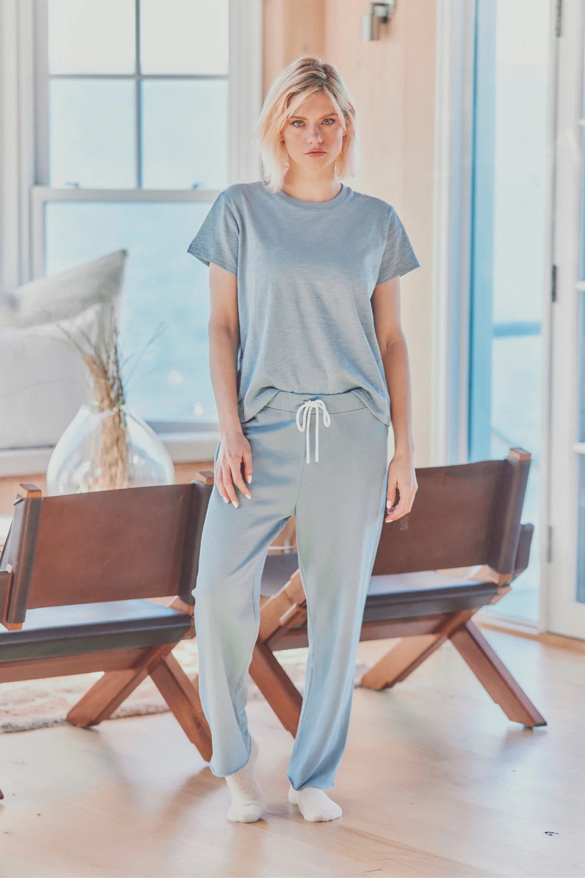 a model in a light blue tee and joggers