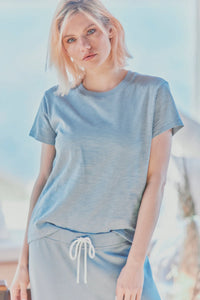 a model in a light blue cotton tee and pants