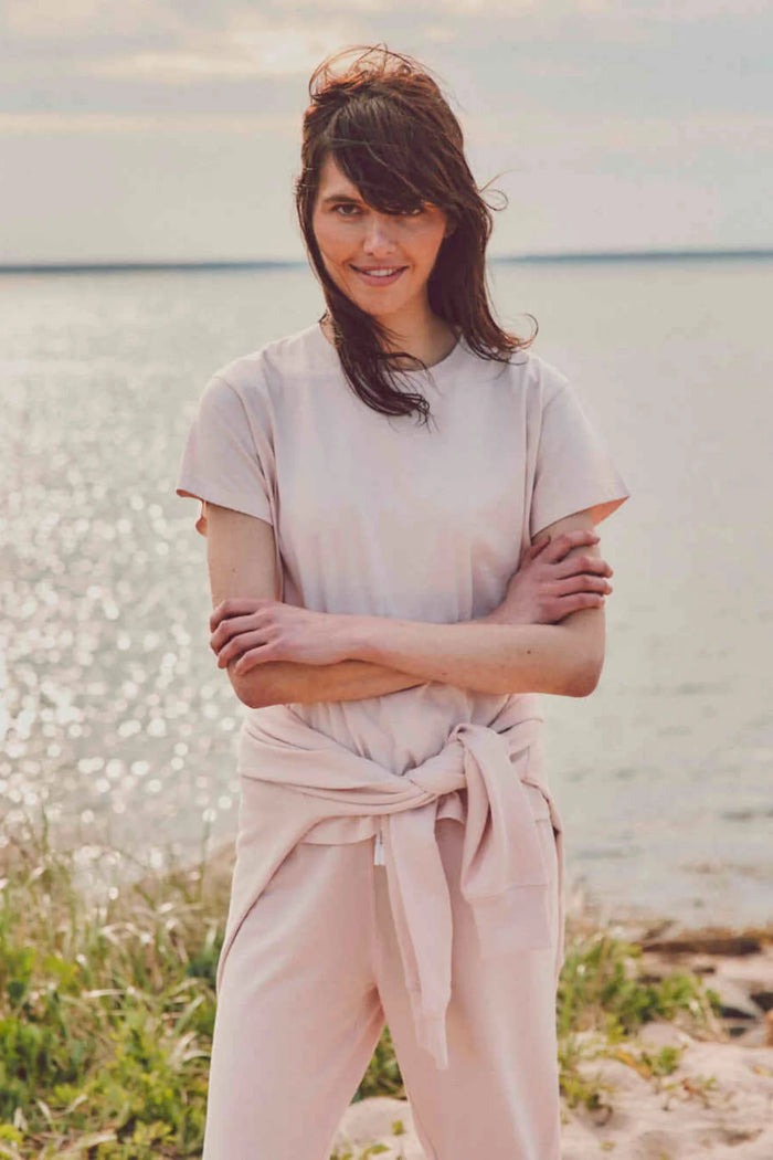 a model outside in a light pink cotton t-shirt