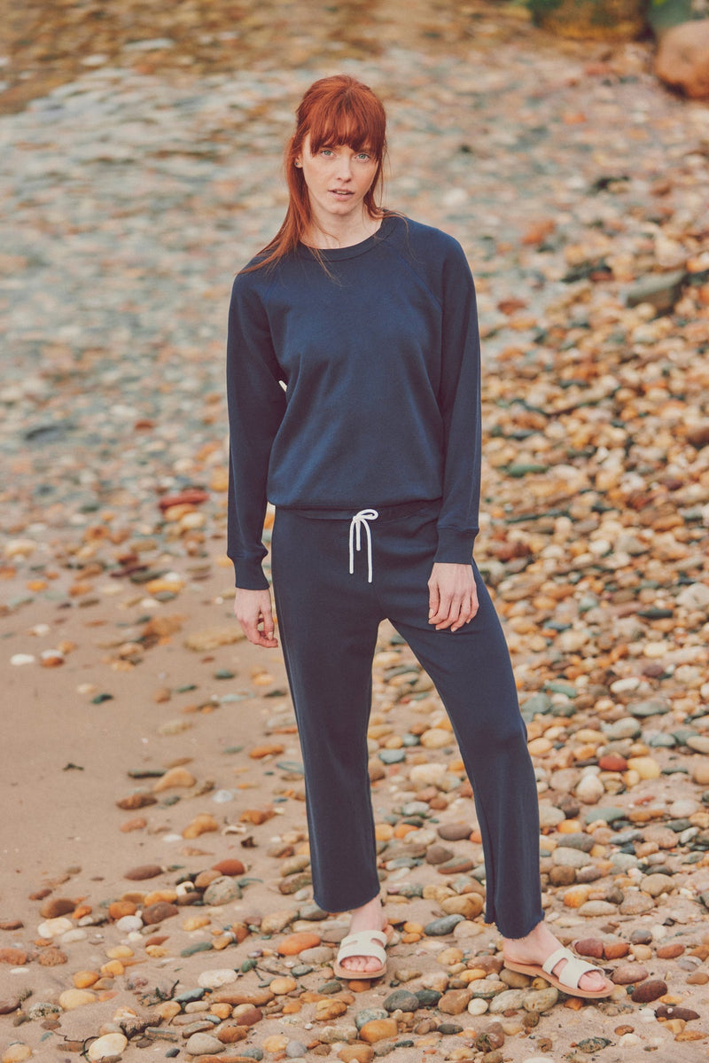 a model in a navy blue matching sweatpants set