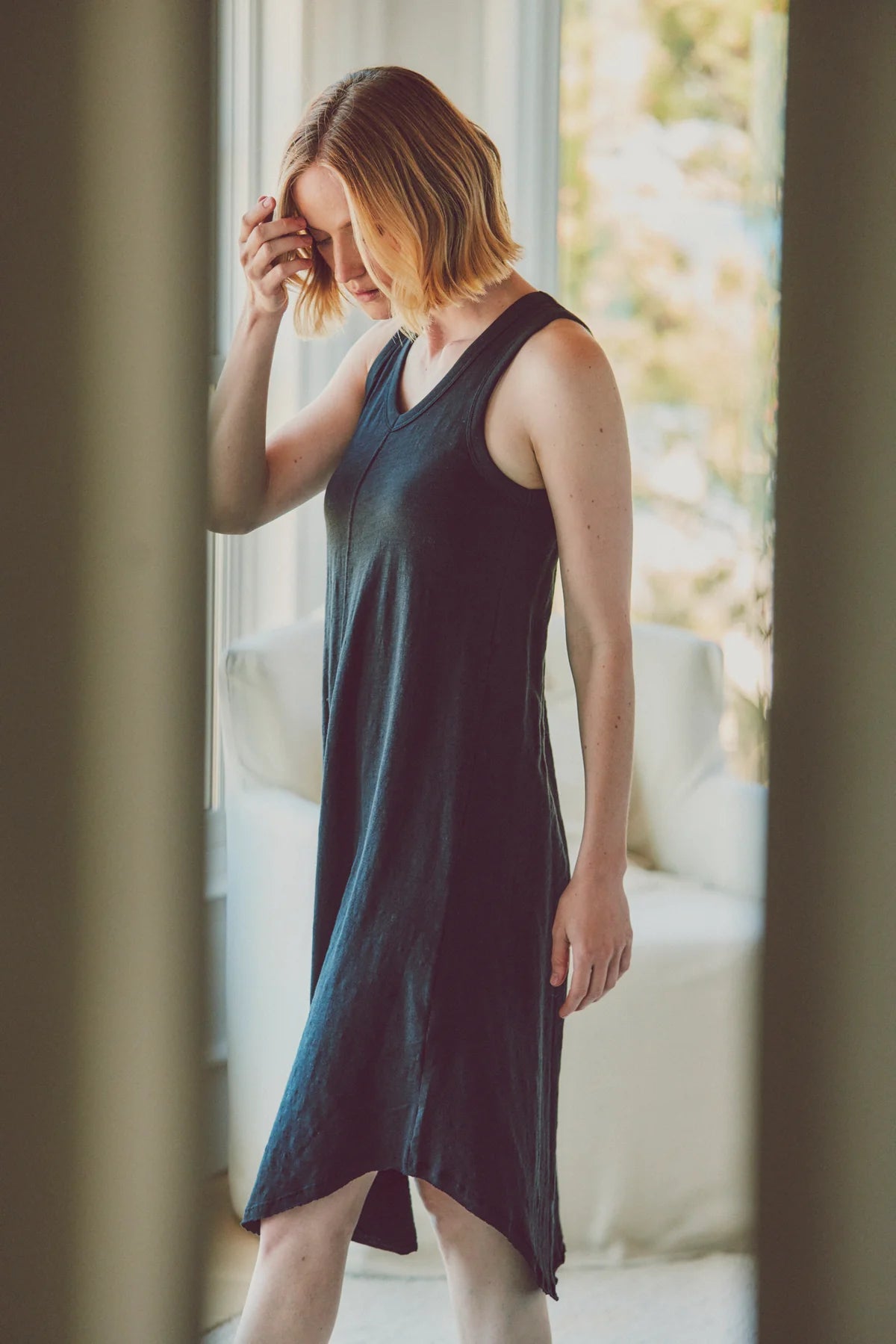 a model in a navy cotton dress