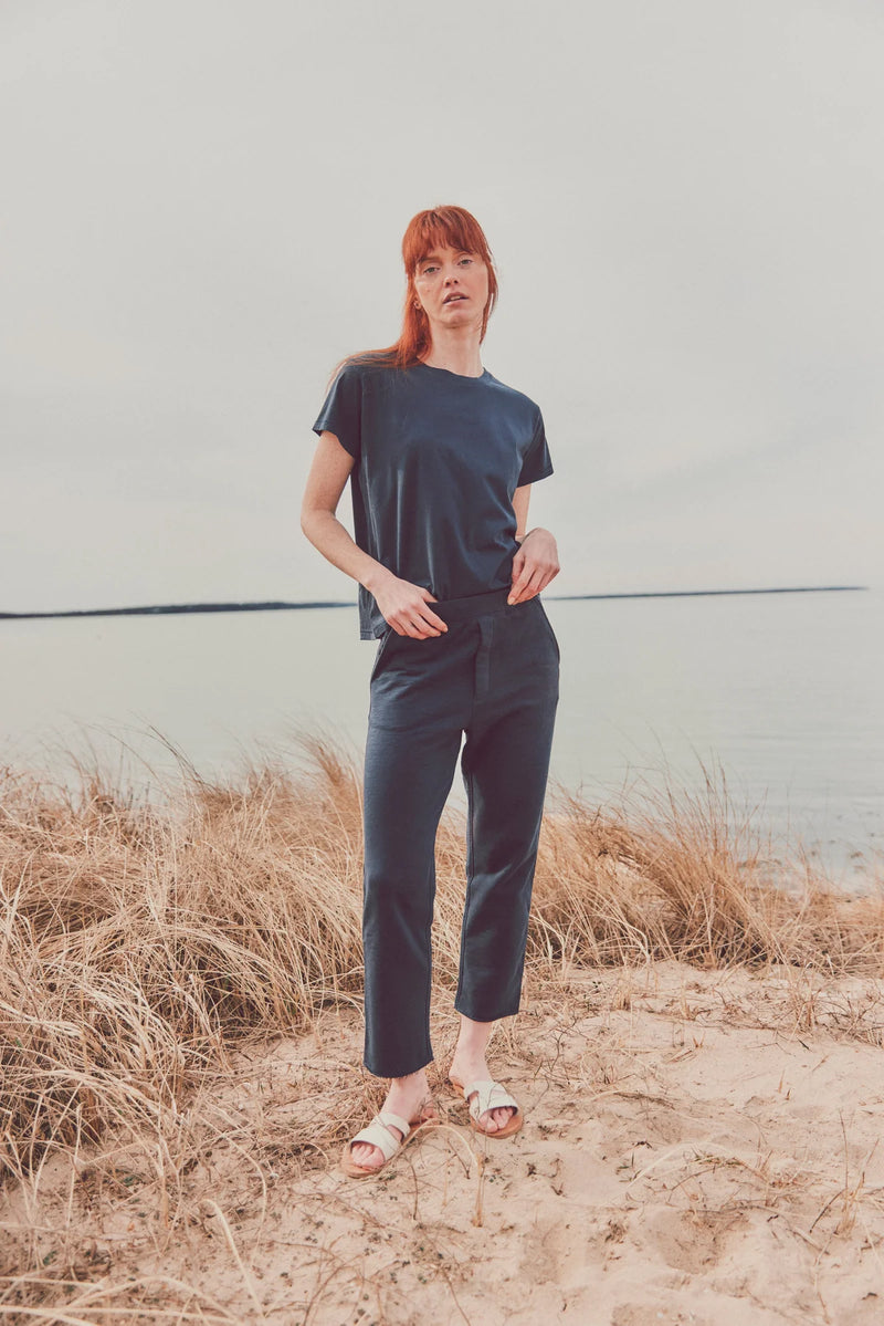 a model outside in a navy-t-shirt and pants