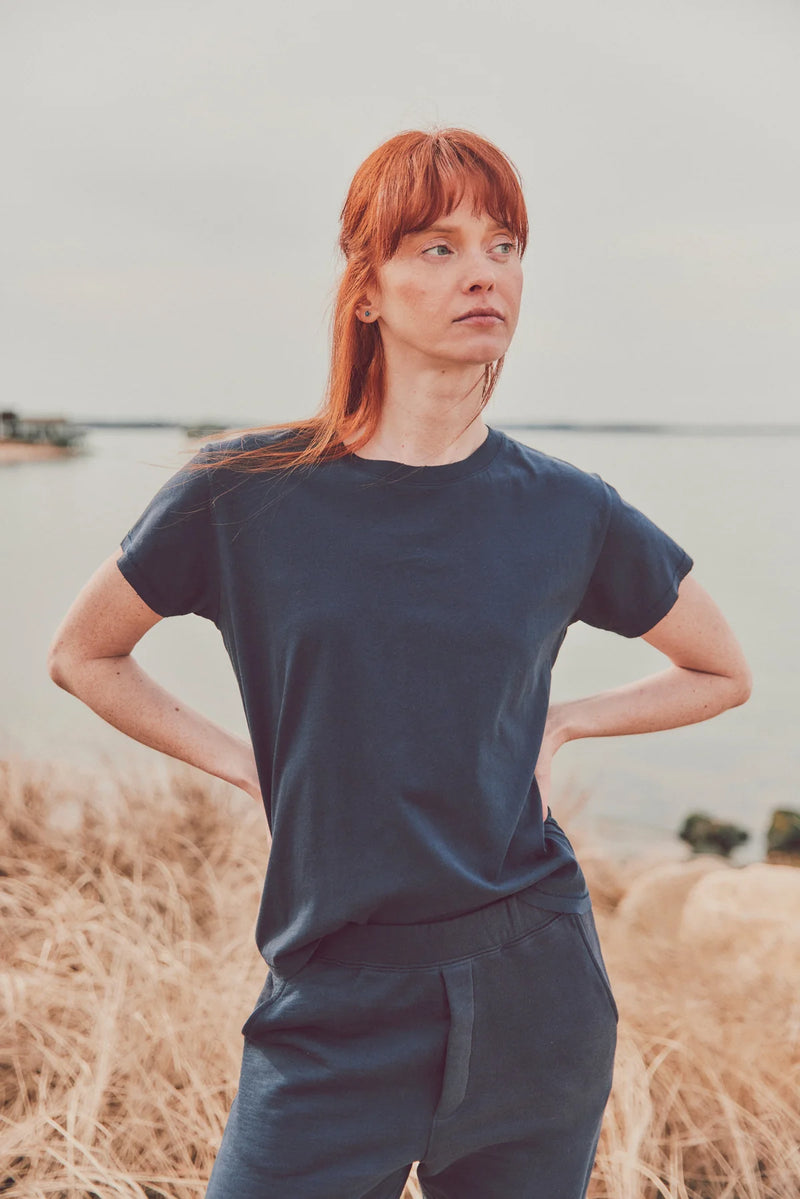 a model with red hair in a navy t-shirt