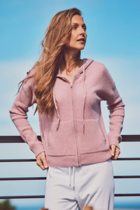 a model in a pink cashmere hoodie