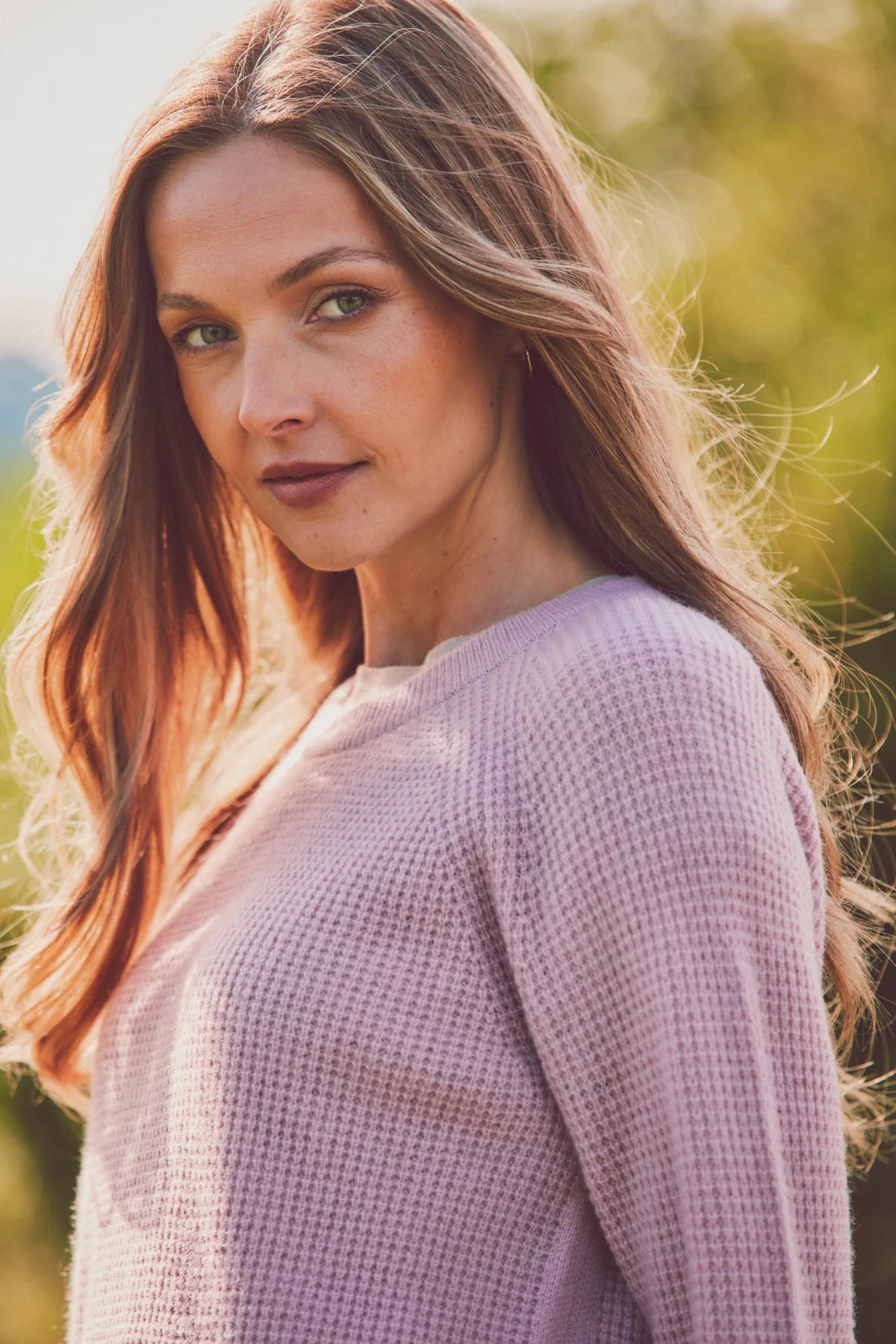 a model in a pink knit sweater