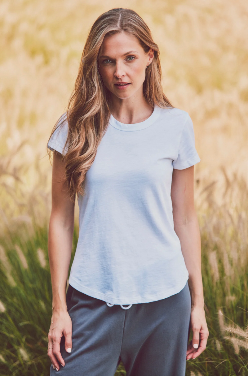 a model in a white fitted scoop neck tee