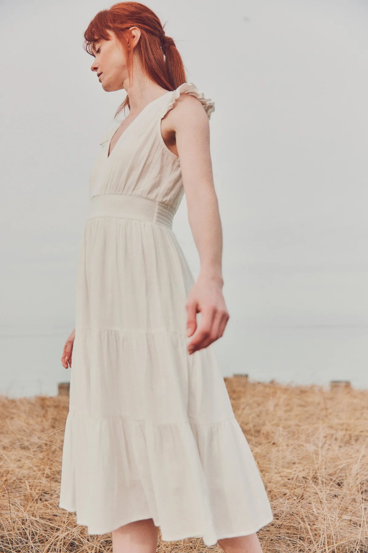 a model in a white cotton gauze dress