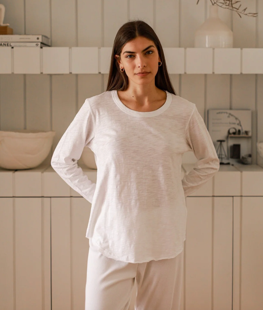 a model in a white long-sleeve tee