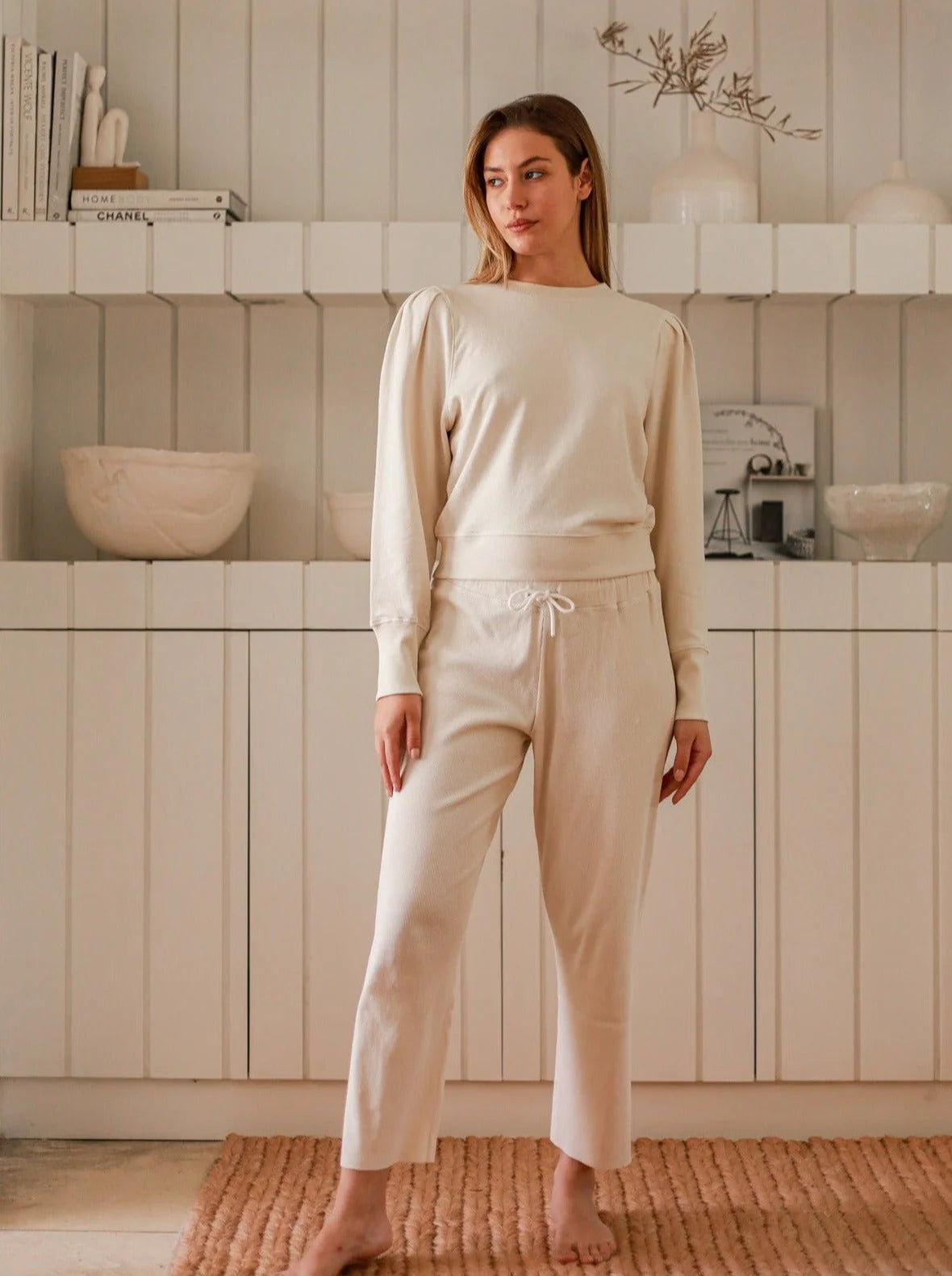 a model in a white matching loungewear set