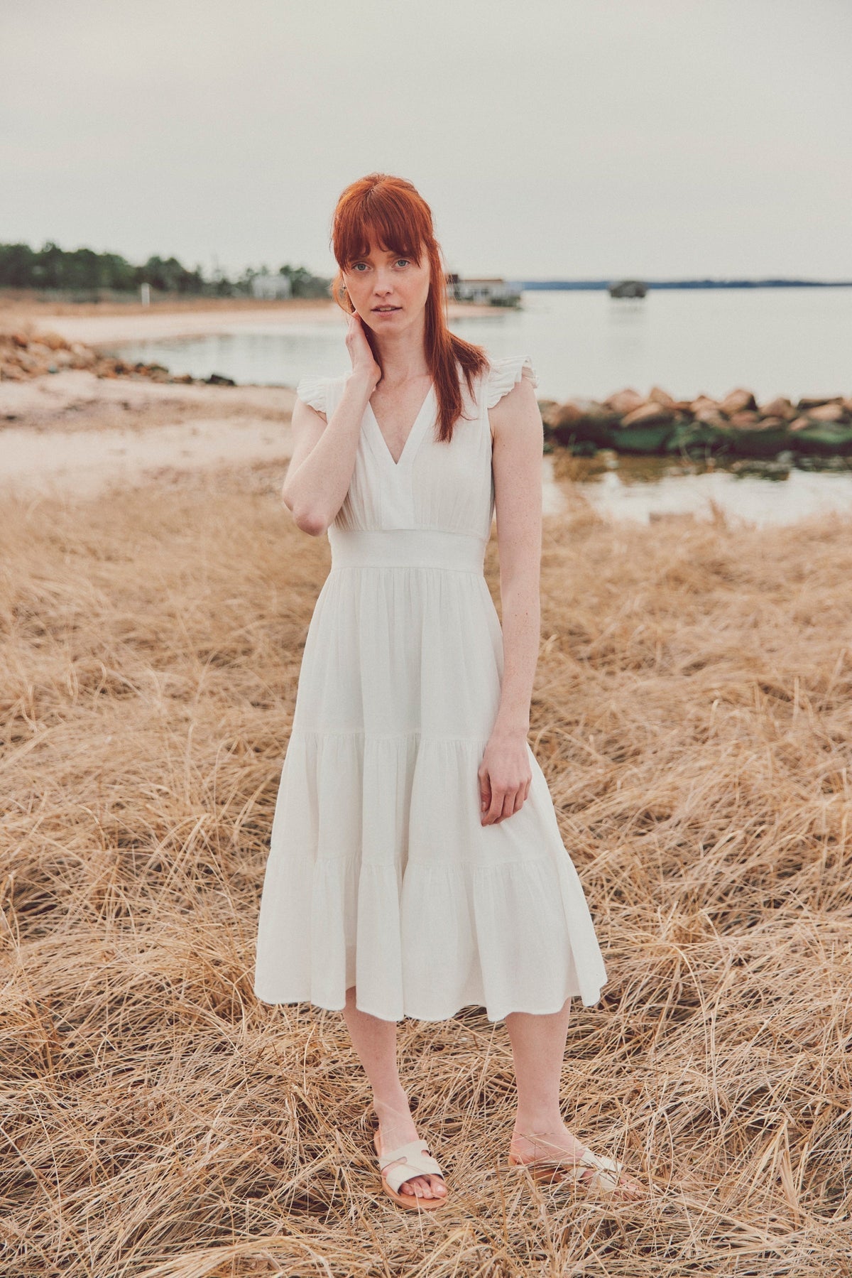a model in a white midi dress