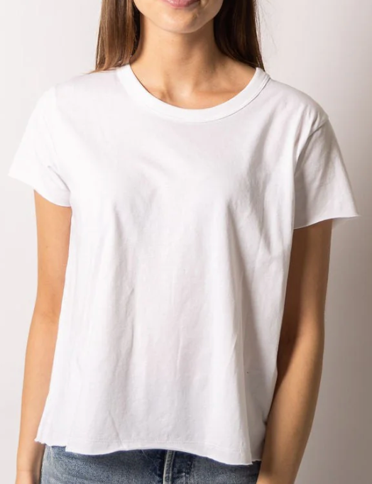 a model in a white raw-edge tee