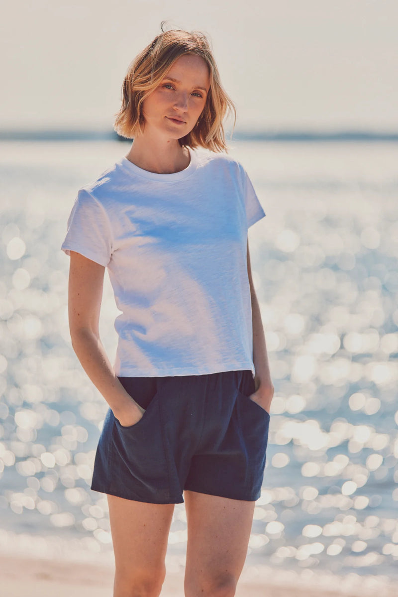 a model in a white tee and navy shorts