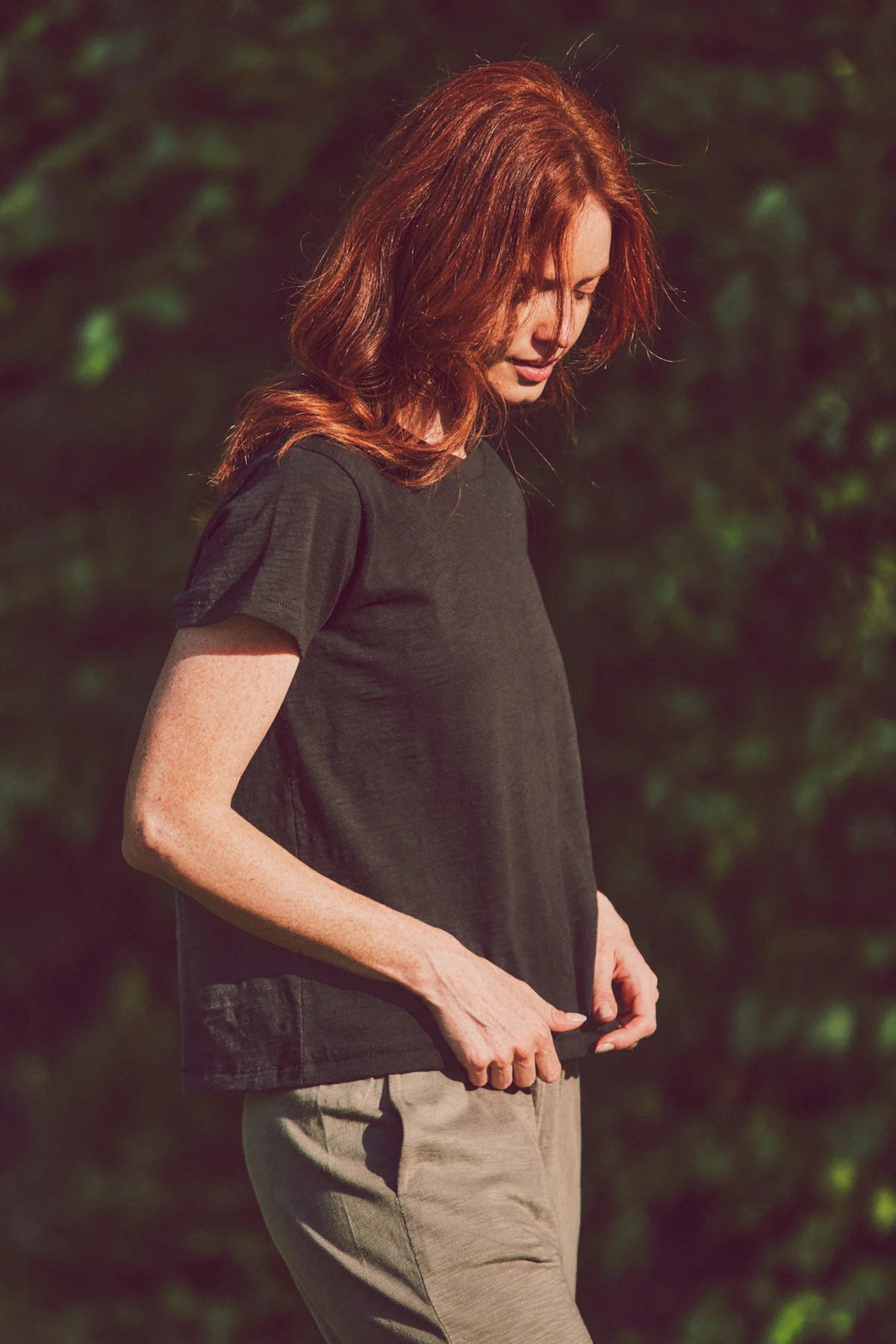 a model looking down in a black tee