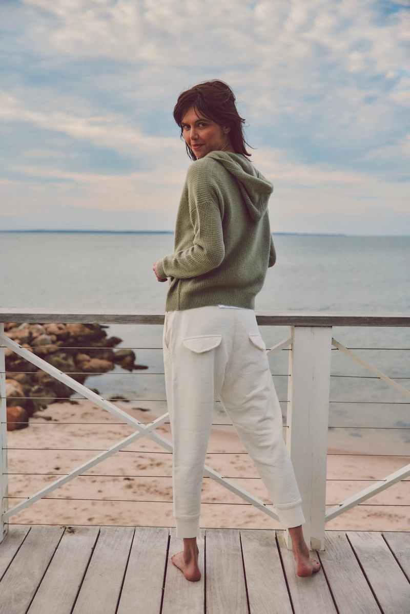 model looking over shoulder in green hoodie