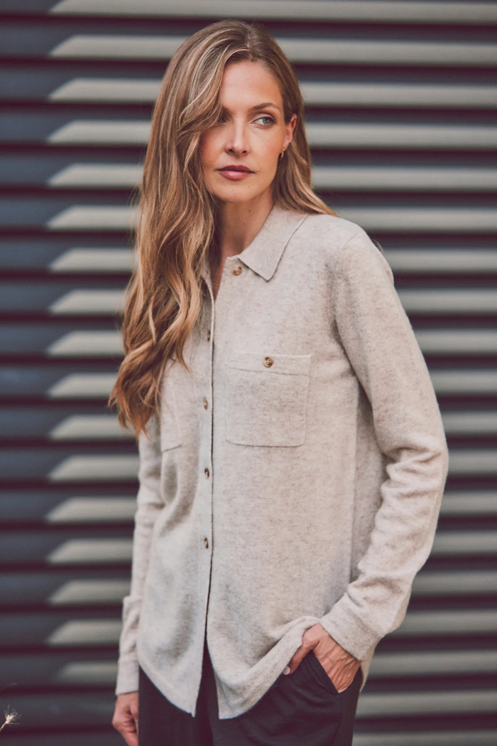 a model looking to the side in a beige cashmere button-up