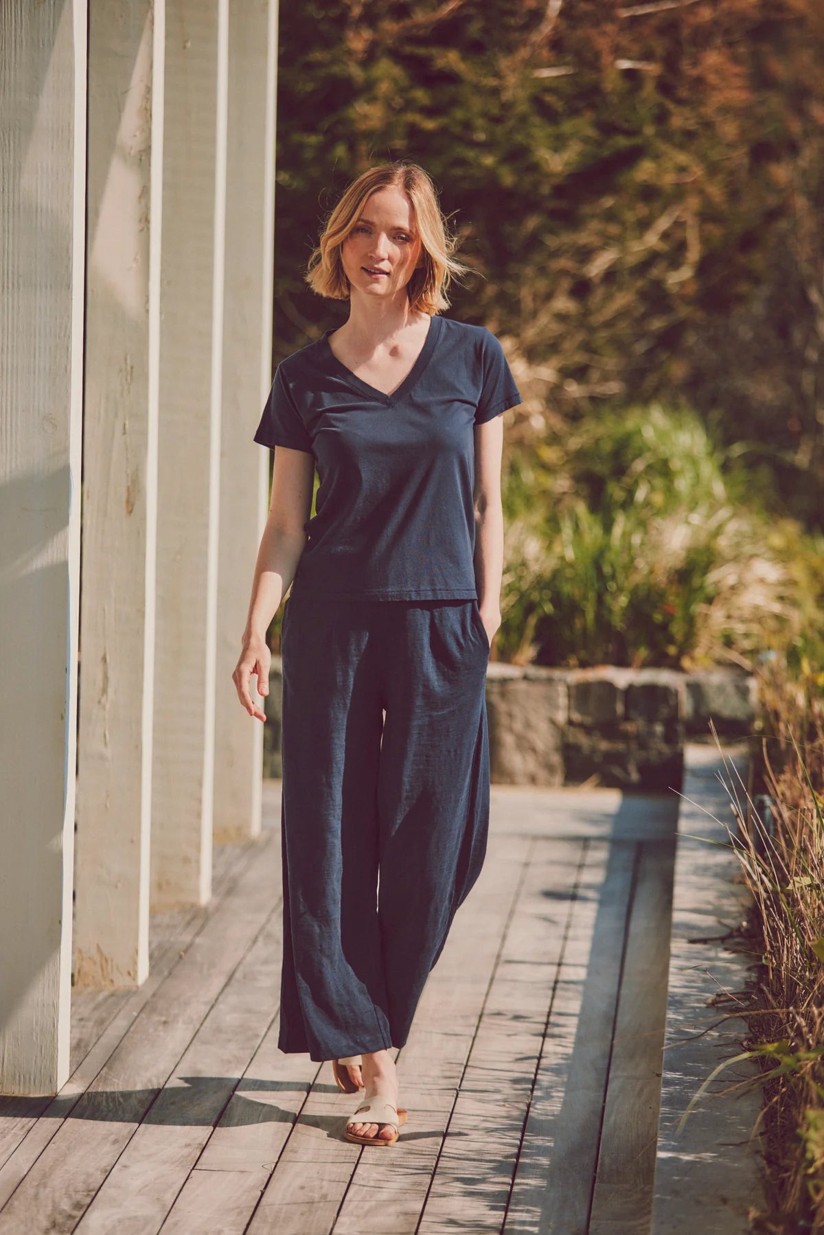 model wearing navy tee and wide-leg pants