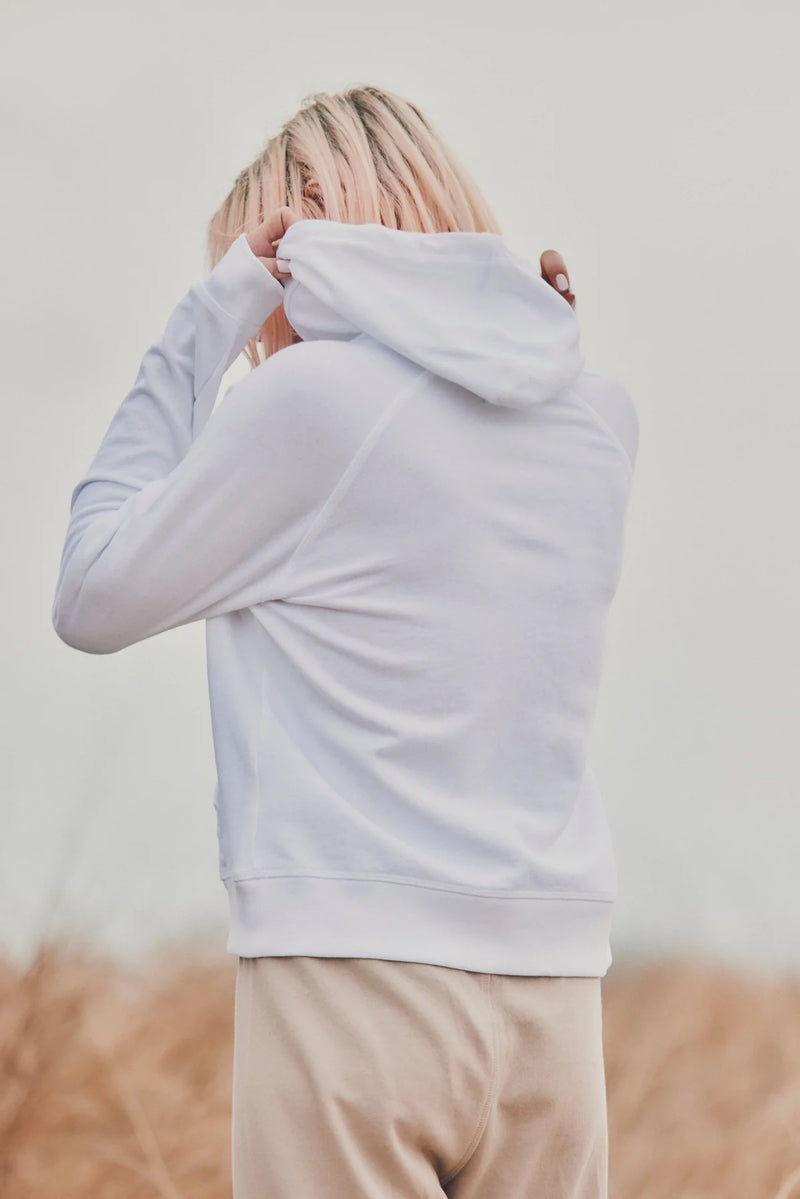 a model showing the back of a white hoodie