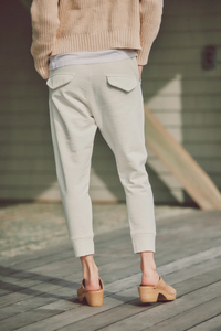 a model showing the back of white joggers