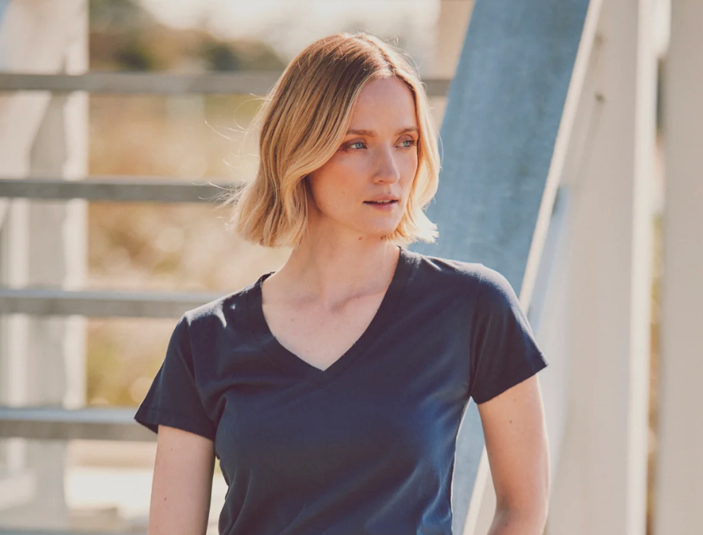 model in a navy distressed v-neck tee