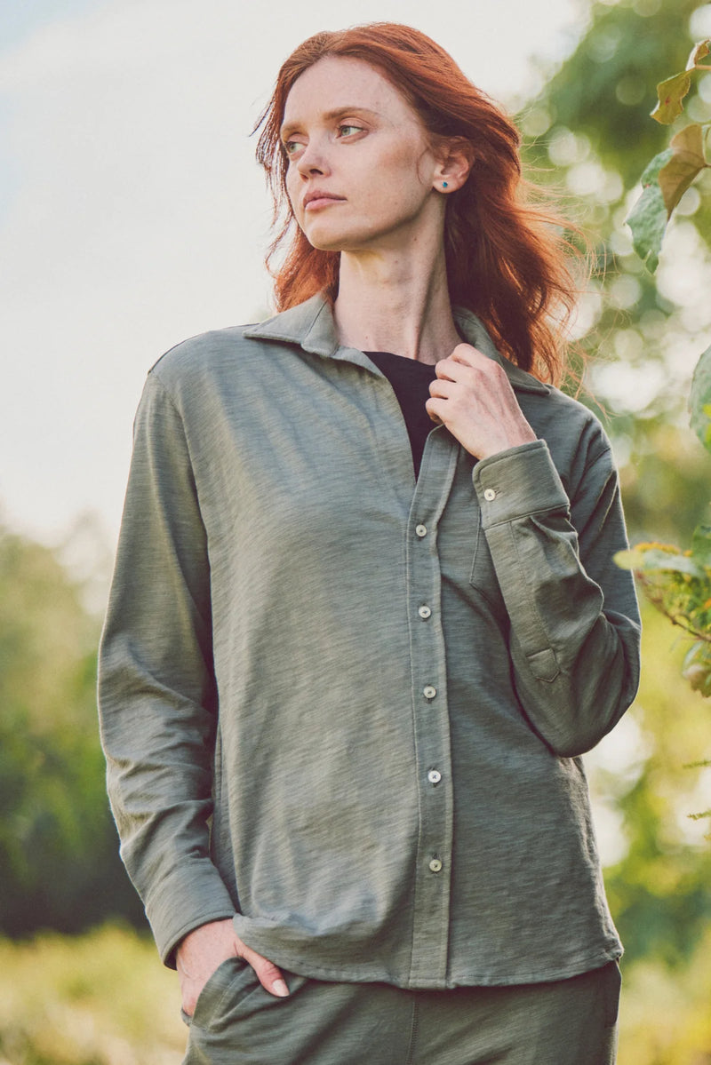 Woman wearing an olive-green button-down