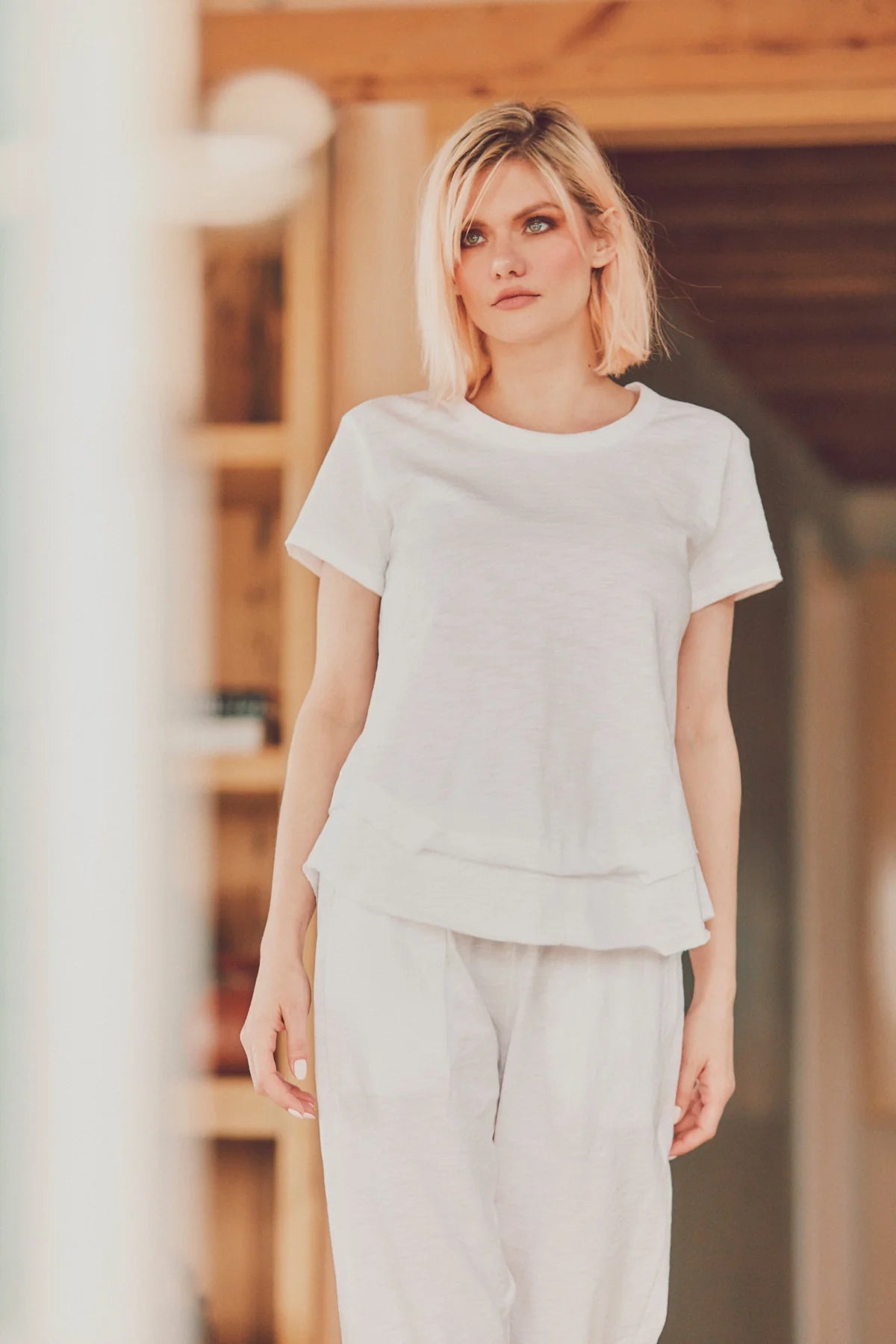 model wearing a ruffle bottom tee with pants